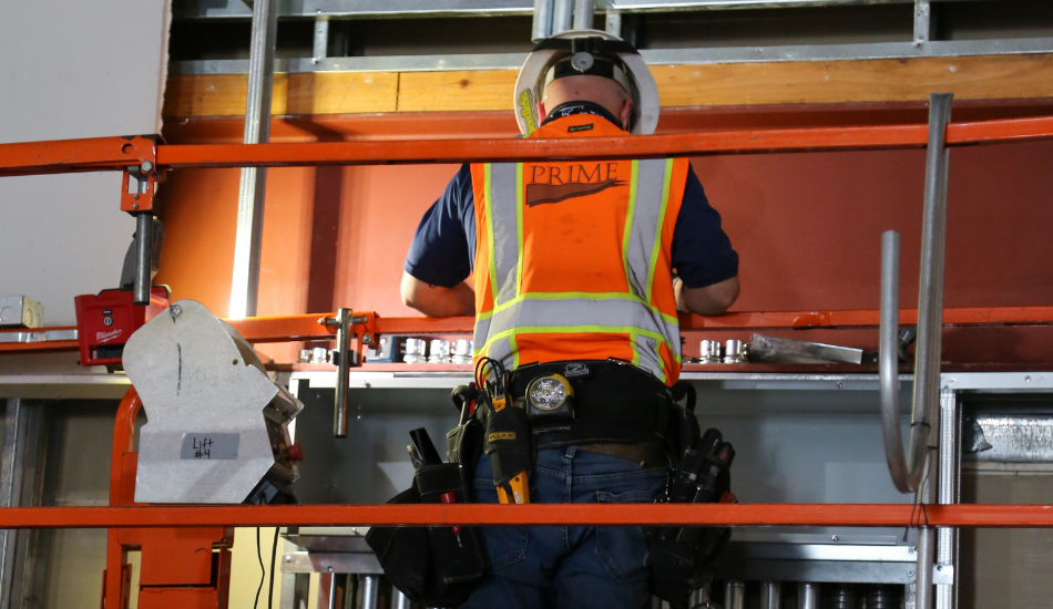 Prime Employee on Lift with Tool Belt