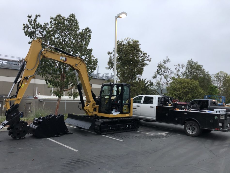 Prime Excavator CAT next to truck